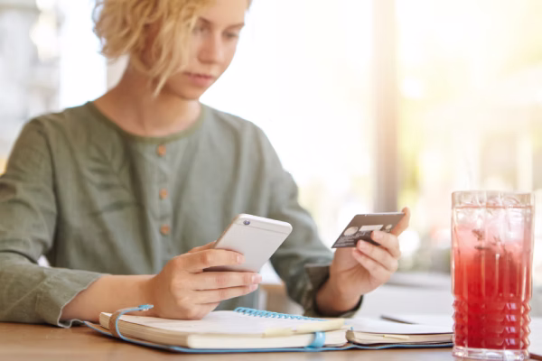 Kobieta sprawdzająca rozliczenia najmu w telefonie
